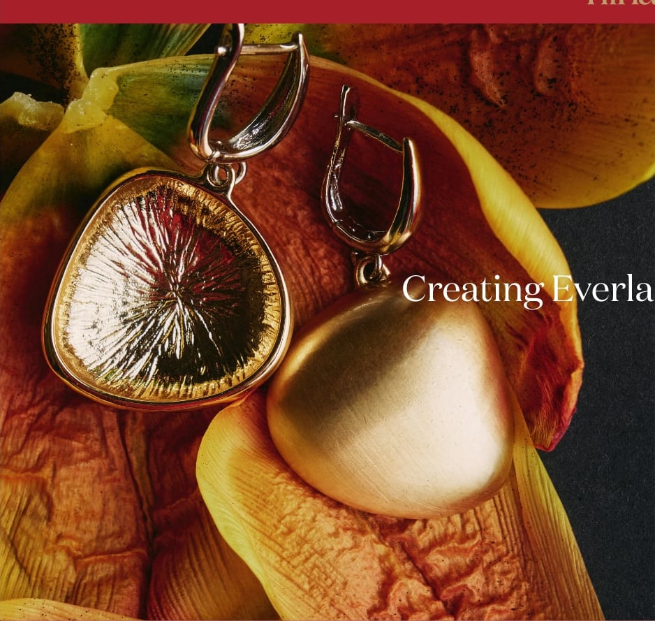 Gold pendant resting on a yellow petal