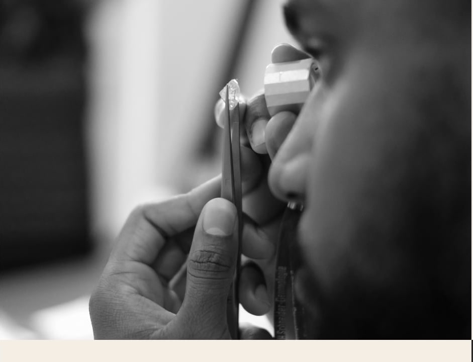 A jeweler examining a stone through a loupe