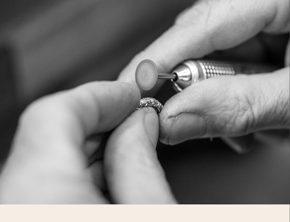 Artisan hands setting a stone into a ring