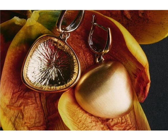 Gold pendant on a yellow petal